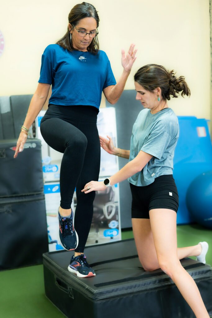 Madison Moon, A Licensed Physical Therapist and Strength and Conditioning coach working with an elderly patient on hip mobility. Madison Moon, A Licensed Physical Therapist and Strength and Conditioning coach working with an elderly patient on hip mobility.